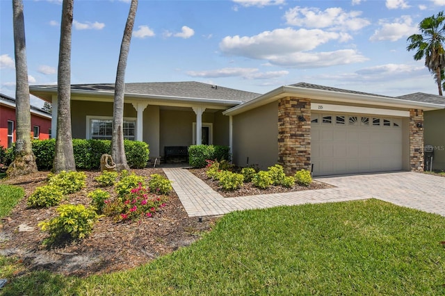 155 Cape Florida Dr, Poinciana, FL 34759 - view of front of house with stucco siding, driveway, a garage, and a front yard
