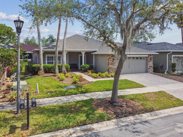 155 Cape Florida Dr, Poinciana, FL 34759 - ranch-style home featuring a front lawn, decorative driveway, stucco siding, and a garage