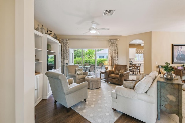 155 Cape Florida Dr, Poinciana, FL 34759 - living room with arched walkways, ceiling fan, visible vents, and wood finished floors