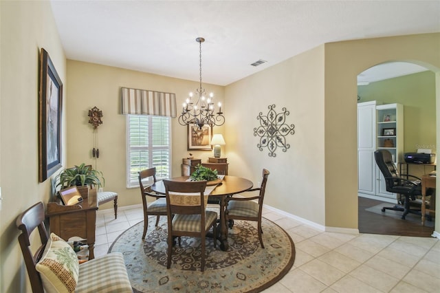 155 Cape Florida Dr, Poinciana, FL 34759 - dining area featuring light tile patterned flooring, baseboards, visible vents, and arched walkways