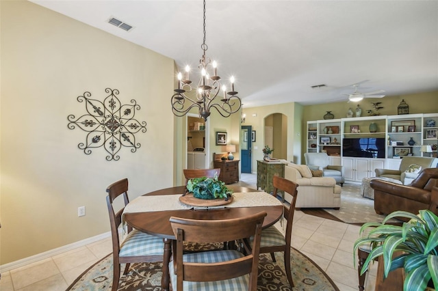 155 Cape Florida Dr, Poinciana, FL 34759 - dining room featuring arched walkways, washer / clothes dryer, visible vents, and light tile patterned floors