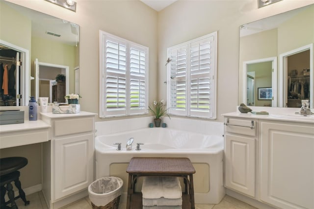 155 Cape Florida Dr, Poinciana, FL 34759 - bathroom with visible vents, a spacious closet, vanity, and a garden tub