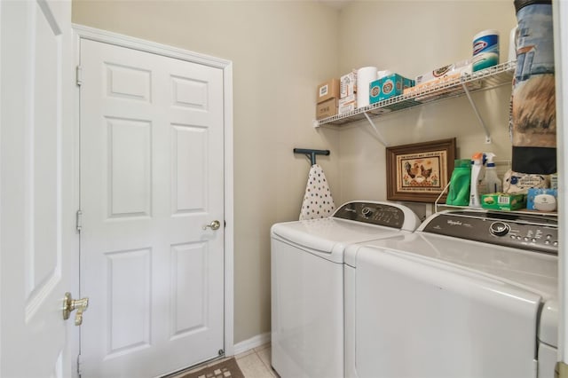155 Cape Florida Dr, Poinciana, FL 34759 - clothes washing area featuring baseboards, separate washer and dryer, laundry area, and light tile patterned floors