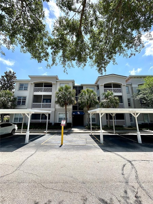 3351 Whitestone Cir Unit 101, Kissimmee, FL 34741 - view of building exterior featuring covered and uncovered parking