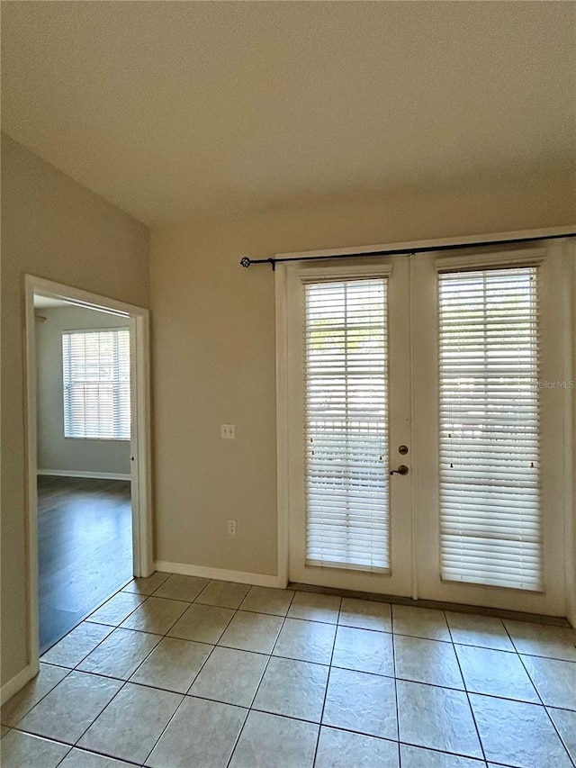 3351 Whitestone Cir Unit 101, Kissimmee, FL 34741 - entryway featuring french doors, light tile patterned floors, and a healthy amount of sunlight