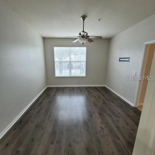 3351 Whitestone Cir Unit 101, Kissimmee, FL 34741 - unfurnished room with baseboards, a ceiling fan, and dark wood finished floors
