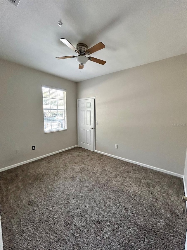 3351 Whitestone Cir Unit 101, Kissimmee, FL 34741 - empty room with baseboards, a ceiling fan, and dark colored carpet