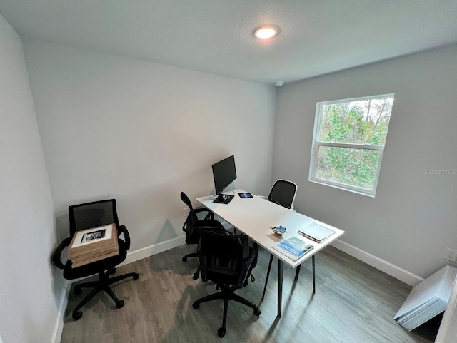 office area featuring baseboards and wood finished floors
