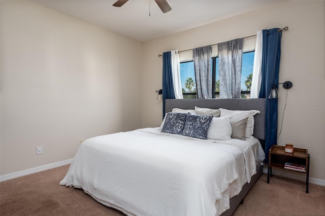 carpeted bedroom featuring baseboards and ceiling fan
