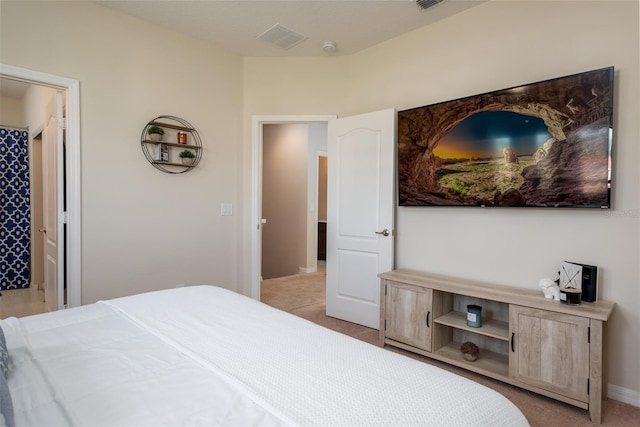 bedroom featuring visible vents and light carpet