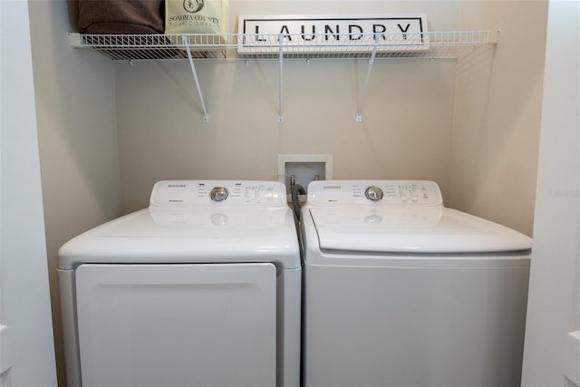 washroom with laundry area and washer and clothes dryer