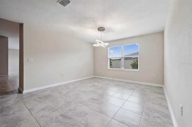 1848 Ancestry Trl, Kissimmee, FL 34746 - spare room featuring a chandelier, light tile patterned flooring, and a textured ceiling