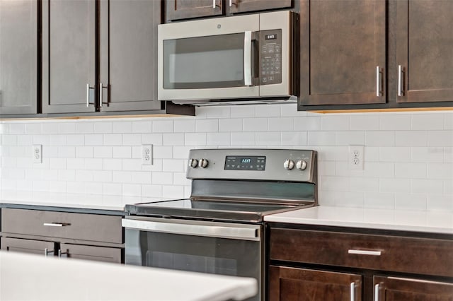 1848 Ancestry Trl, Kissimmee, FL 34746 - kitchen featuring appliances with stainless steel finishes, dark brown cabinets, decorative backsplash, and light countertops
