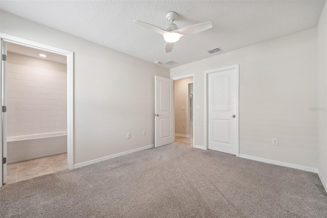 1848 Ancestry Trl, Kissimmee, FL 34746 - unfurnished bedroom with carpet floors, a textured ceiling, and a ceiling fan