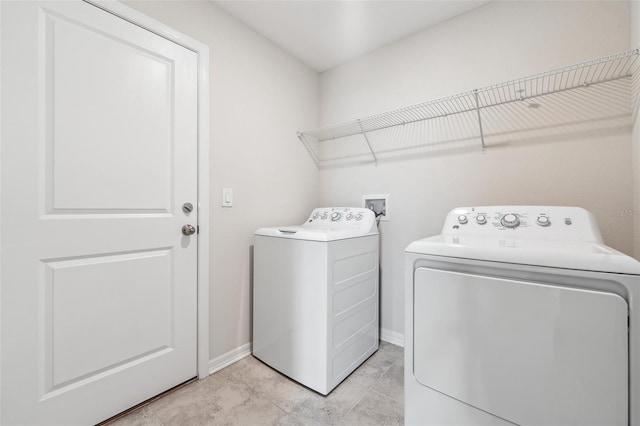 1848 Ancestry Trl, Kissimmee, FL 34746 - laundry room with washing machine and clothes dryer and baseboards