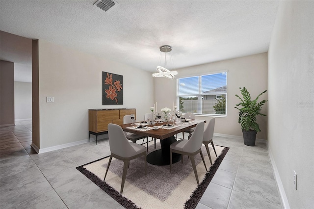 1848 Ancestry Trl, Kissimmee, FL 34746 - dining space with a chandelier, a textured ceiling, and light tile patterned floors