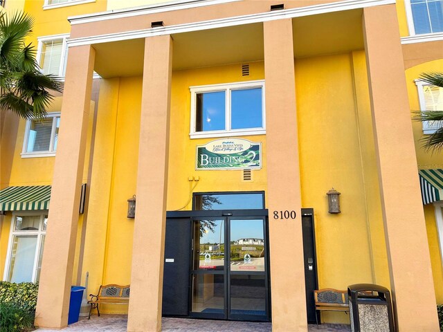 8100 Poinciana Blvd Unit 2111, Orlando, FL 32821 - property entrance featuring stucco siding