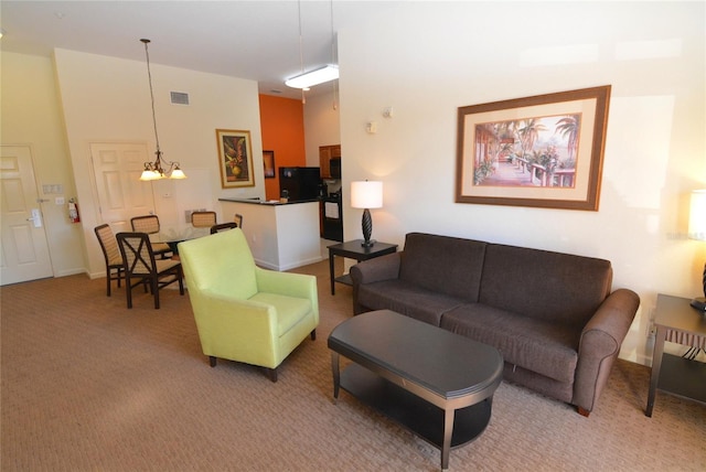 8100 Poinciana Blvd Unit 2111, Orlando, FL 32821 - living area with an inviting chandelier, light carpet, and visible vents
