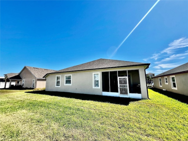 2920 River Birch Dr, Kissimmee, FL 34741 - rear view of property with a lawn, stucco siding, and a sunroom