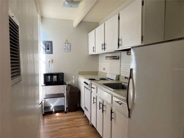 kitchen featuring white cabinets, light countertops, white appliances, backsplash, and light wood-style flooring