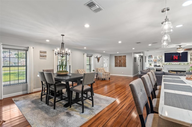 1999 Sir Lancelot Cir, Saint Cloud, FL 34772 - dining space with wood finished floors, ceiling fan with notable chandelier, a wealth of natural light, visible vents, and recessed lighting