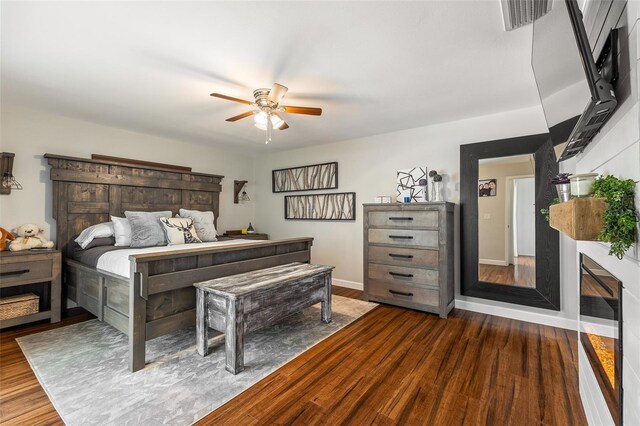 1999 Sir Lancelot Cir, Saint Cloud, FL 34772 - bedroom featuring visible vents, a ceiling fan, baseboards, and dark wood-style flooring