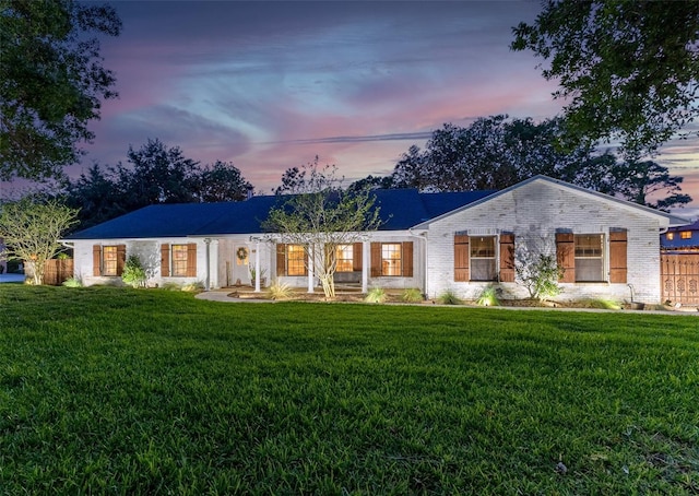 1999 Sir Lancelot Cir, Saint Cloud, FL 34772 - view of front of house with brick siding, a front lawn, and fence