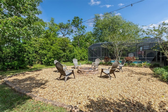 1999 Sir Lancelot Cir, Saint Cloud, FL 34772 - view of yard featuring a lanai, an outdoor pool, a patio area, and an outdoor fire pit