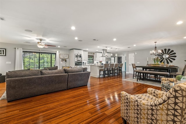1999 Sir Lancelot Cir, Saint Cloud, FL 34772 - living area featuring recessed lighting, dark wood finished floors, visible vents, and ceiling fan with notable chandelier
