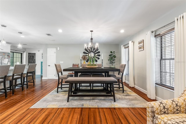 1999 Sir Lancelot Cir, Saint Cloud, FL 34772 - dining space with baseboards, a chandelier, wood finished floors, and recessed lighting