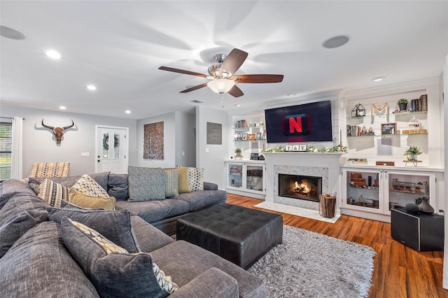 1999 Sir Lancelot Cir, Saint Cloud, FL 34772 - living room featuring a fireplace with flush hearth, a ceiling fan, wood finished floors, and recessed lighting