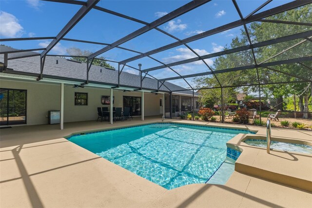 1999 Sir Lancelot Cir, Saint Cloud, FL 34772 - view of swimming pool featuring ceiling fan, glass enclosure, a patio area, and a pool with connected hot tub