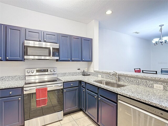 kitchen with stainless steel appliances, an inviting chandelier, visible vents, light tile patterned floors, and a sink