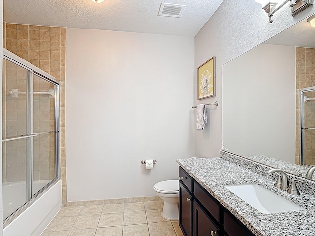 bathroom featuring vanity, shower / bath combination with glass door, toilet, tile patterned flooring, and visible vents