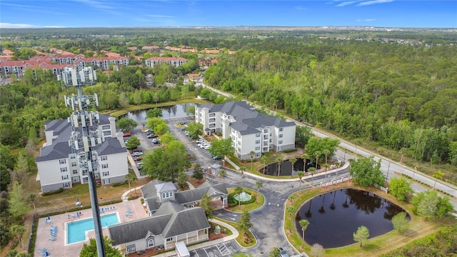 drone / aerial view featuring a forest view and a water view