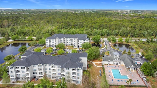 aerial view featuring a view of trees and a water view