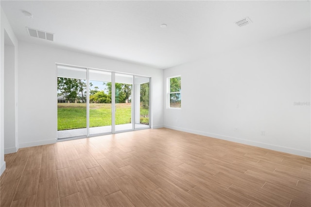 9143 Players Dr, Weeki Wachee, FL 34613 - unfurnished room with light wood finished floors and a smoke detector