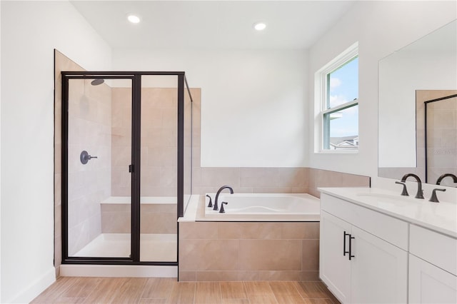9143 Players Dr, Weeki Wachee, FL 34613 - bathroom with a bath, vanity, a stall shower, wood finished floors, and recessed lighting