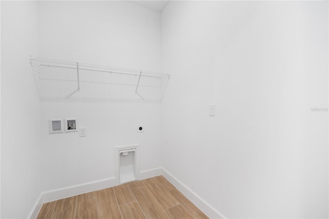 9143 Players Dr, Weeki Wachee, FL 34613 - laundry area with electric dryer hookup, hookup for a washing machine, and light wood-style floors