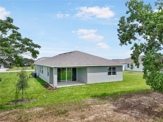 9143 Players Dr, Weeki Wachee, FL 34613 - rear view of house with stucco siding, a patio area, a lawn, and a shingled roof