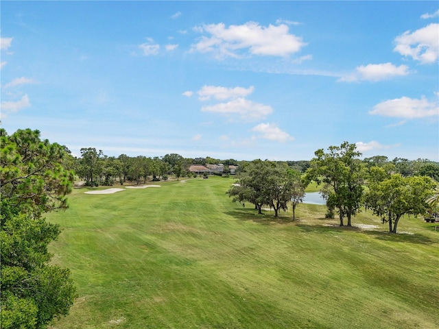 9143 Players Dr, Weeki Wachee, FL 34613 - view of community with golf course view, a yard, and view of wooded area