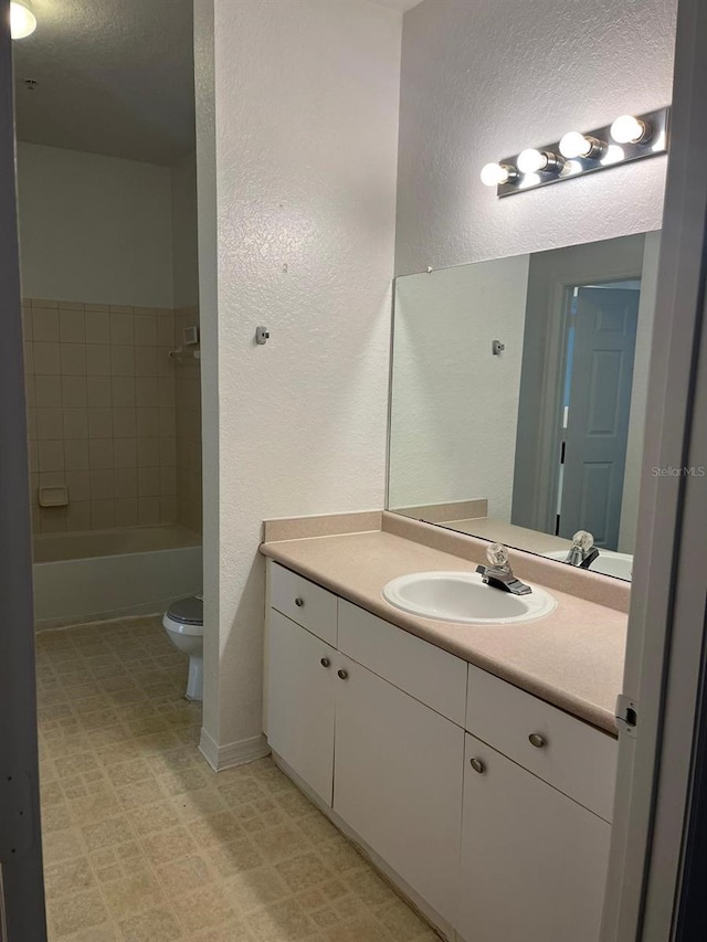 2314 Midtown Ter Unit 1113, Orlando, FL 32839 - full bathroom with a textured ceiling, toilet, tile patterned floors, vanity, and a textured wall