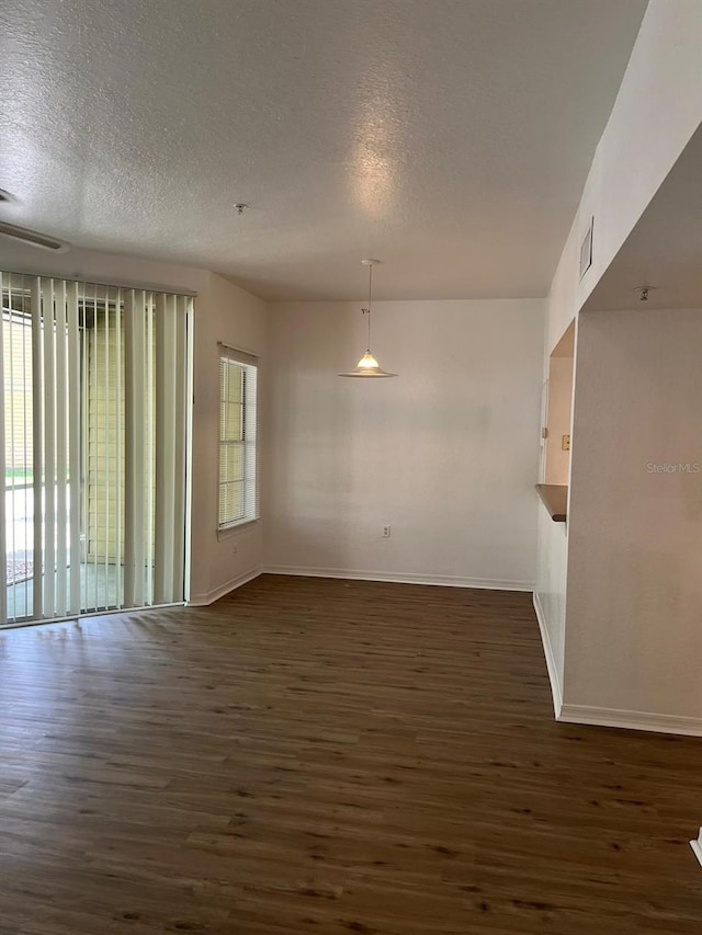 2314 Midtown Ter Unit 1113, Orlando, FL 32839 - spare room featuring baseboards, a textured ceiling, and dark wood finished floors