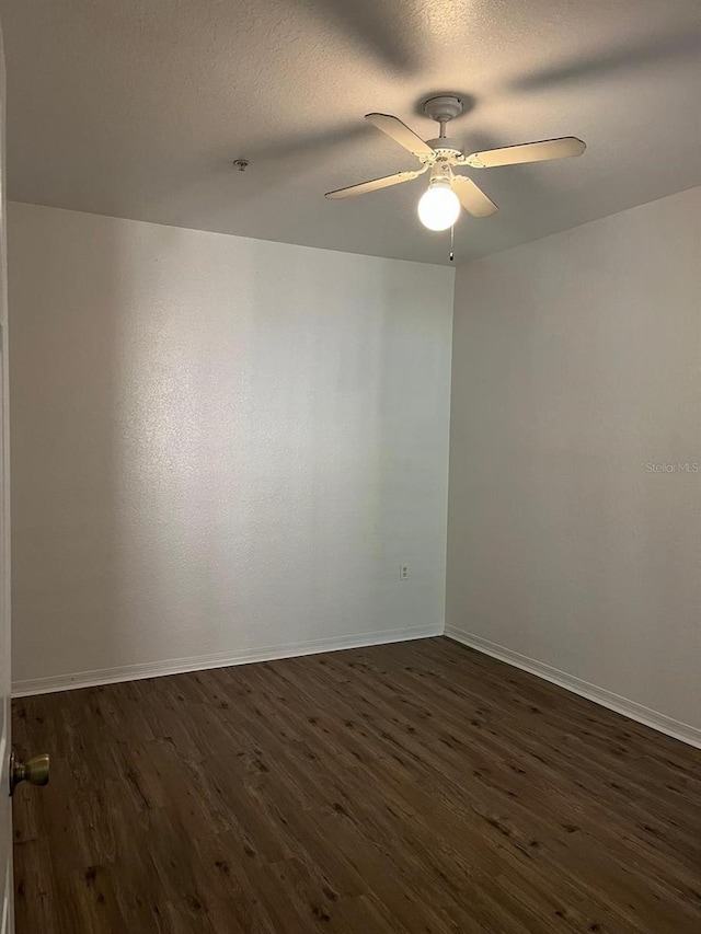 2314 Midtown Ter Unit 1113, Orlando, FL 32839 - empty room with dark wood-type flooring, a textured ceiling, ceiling fan, and baseboards