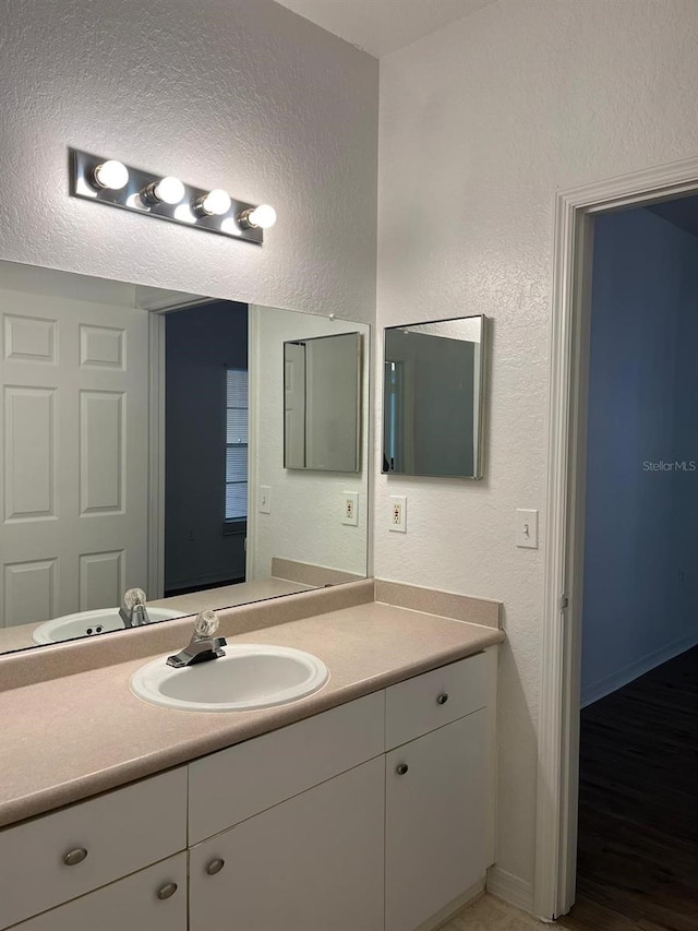 2314 Midtown Ter Unit 1113, Orlando, FL 32839 - bathroom featuring a textured wall, vanity, and a textured ceiling