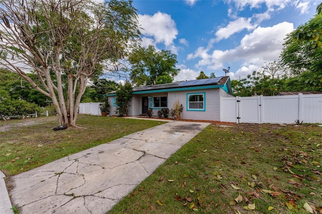 710 E Court, Longwood, FL 32750 - view of front of house with a gate, fence, concrete driveway, a front yard, and solar panels