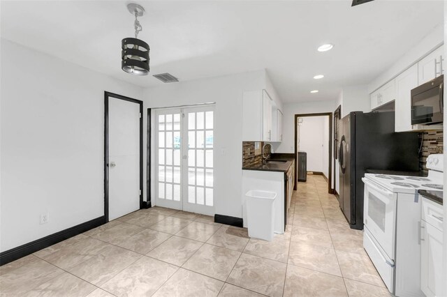 710 E Court, Longwood, FL 32750 - kitchen featuring a sink, dark countertops, white electric stove, white cabinets, and black microwave
