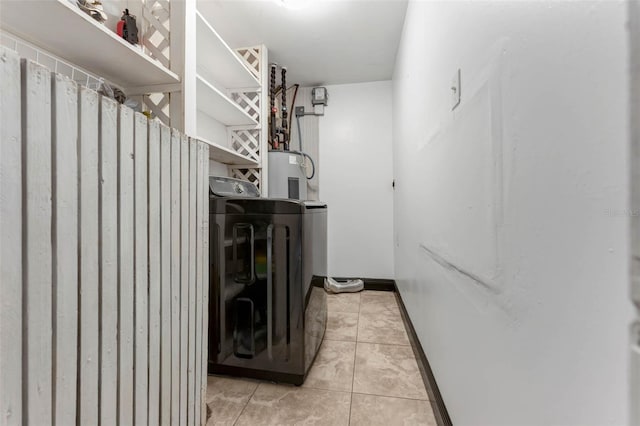 710 E Court, Longwood, FL 32750 - clothes washing area with baseboards, washer / clothes dryer, laundry area, water heater, and light tile patterned floors