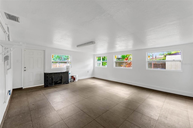 710 E Court, Longwood, FL 32750 - unfurnished living room with baseboards, a textured ceiling, and visible vents