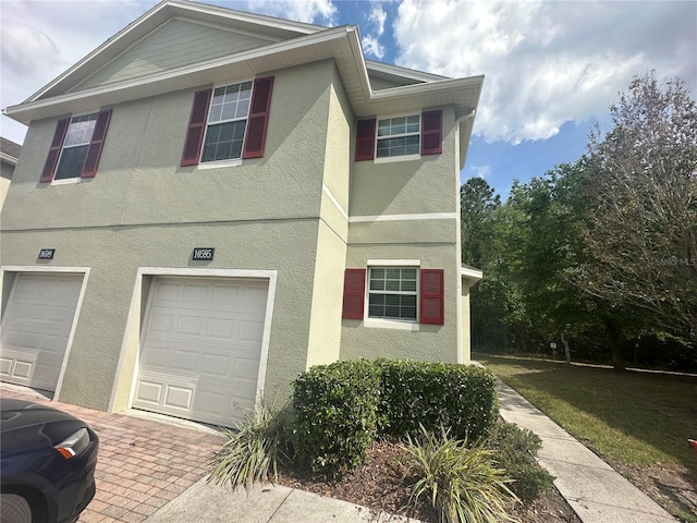10595 Regent Square Dr Unit 1208, Orlando, FL 32825 - view of front facade featuring stucco siding and a garage